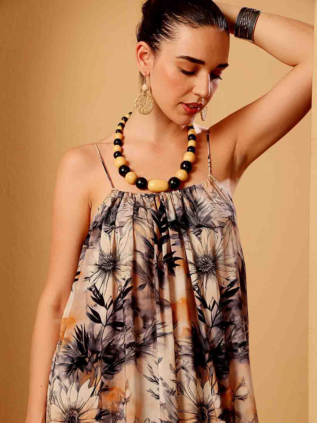 Close-up of tropical floral resort dress emphasizing fabric texture and detailed finish