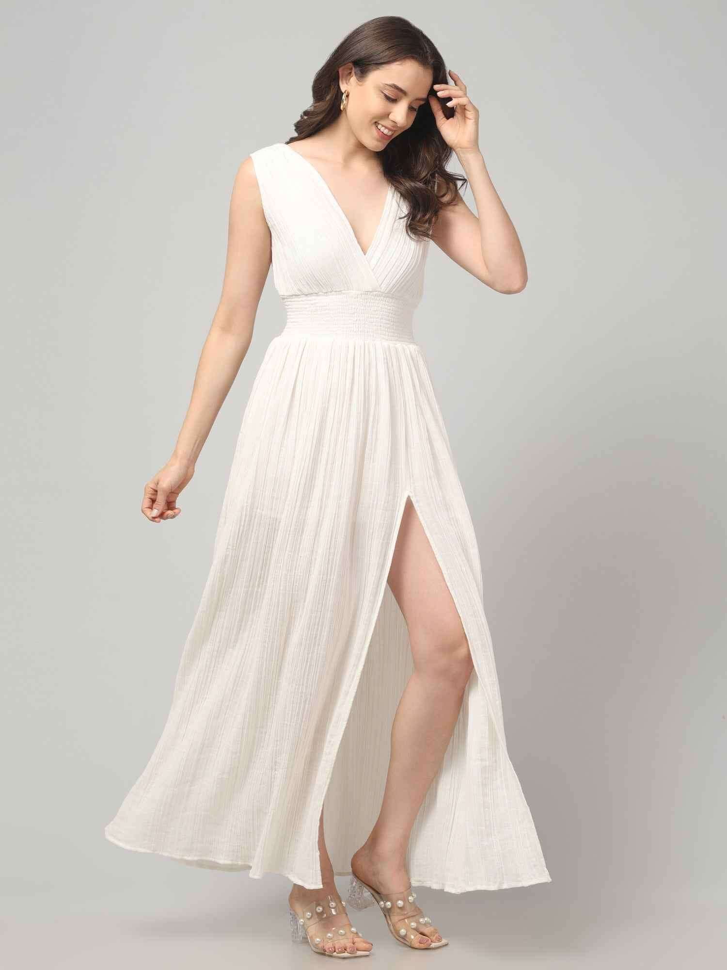 Side profile of a women wearing Crinkled Cotton white Flowy resort maxi dress with Front Slit