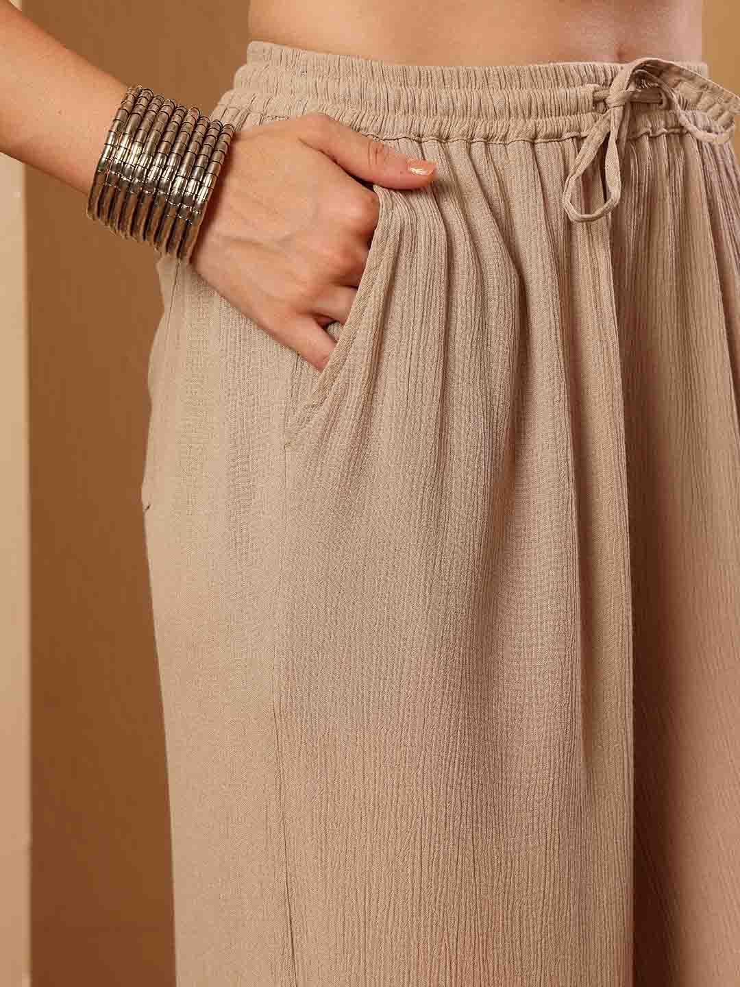 Close up view of Pink resort flared pants focusing on drape and contour
