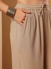 Close up view of Pink resort flared pants focusing on drape and contour

