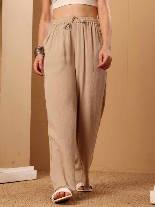 Front view of Beige resort flared pants displaying the silhouette and fall clearly