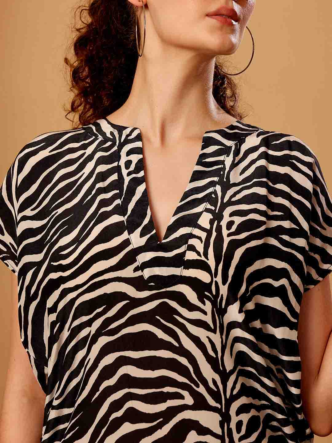 Close-up of Black animal printed beach coverup emphasizing fabric texture and detailed finish
