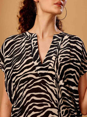 Close-up of Black animal printed beach coverup emphasizing fabric texture and detailed finish
