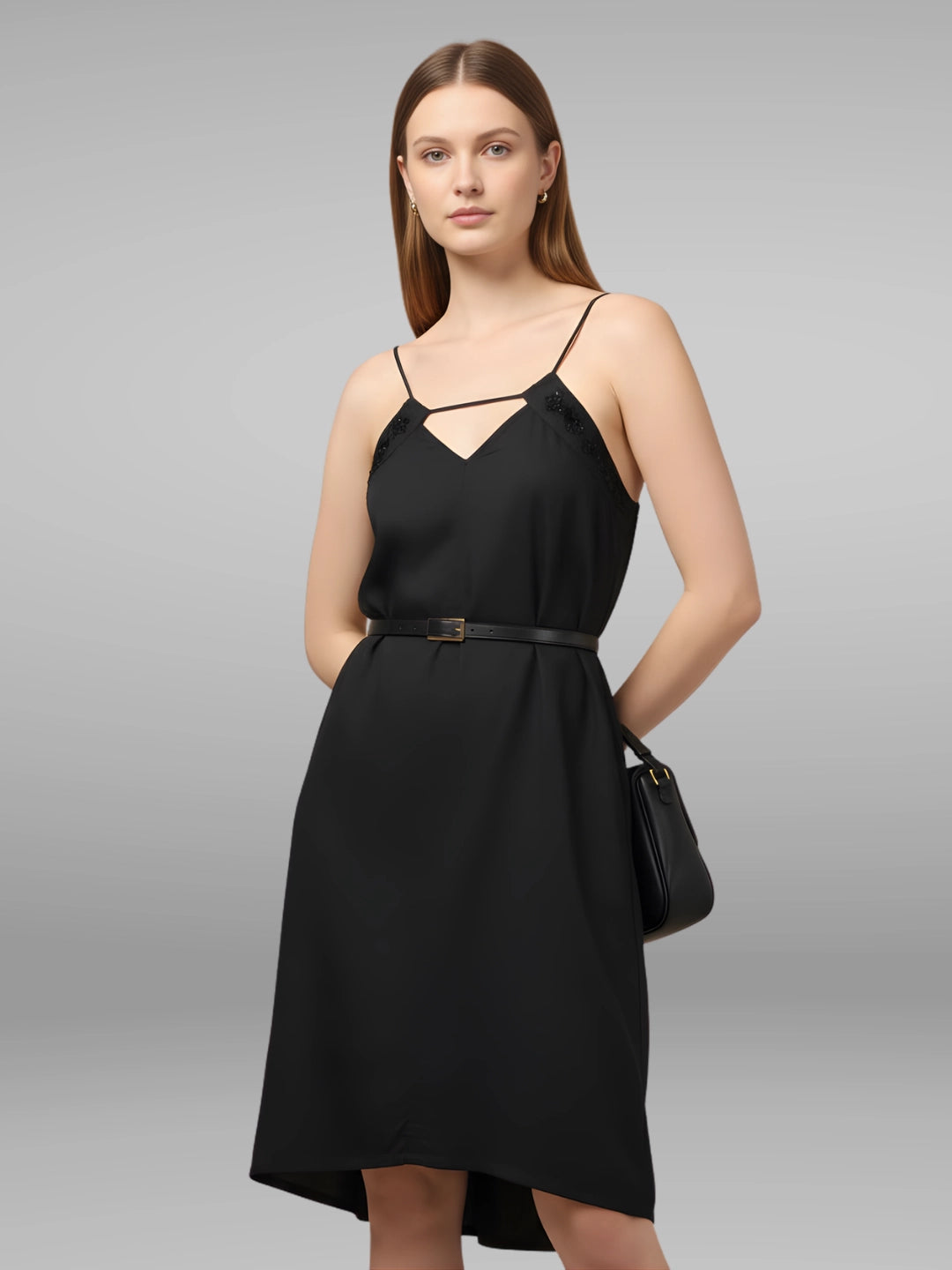 Women wearing a black resort wear cocktail dress with noodle strap and black embellishment on neckline