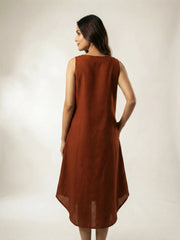 back pose of a women wearing a copper summer resort dress with high low hemline