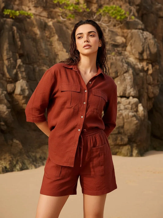 Woman wearing a copper outfit standing against a rocky background