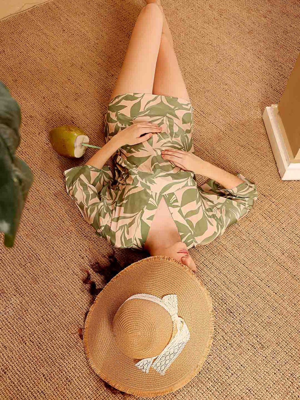 Stylized campaign shot of Green printed beach coverup in a scenic resort setting

