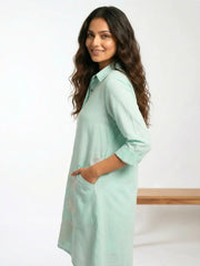 Side profile of a women wearing a cotton Linen Mint color vacation Shirt dress with Birds embroidery