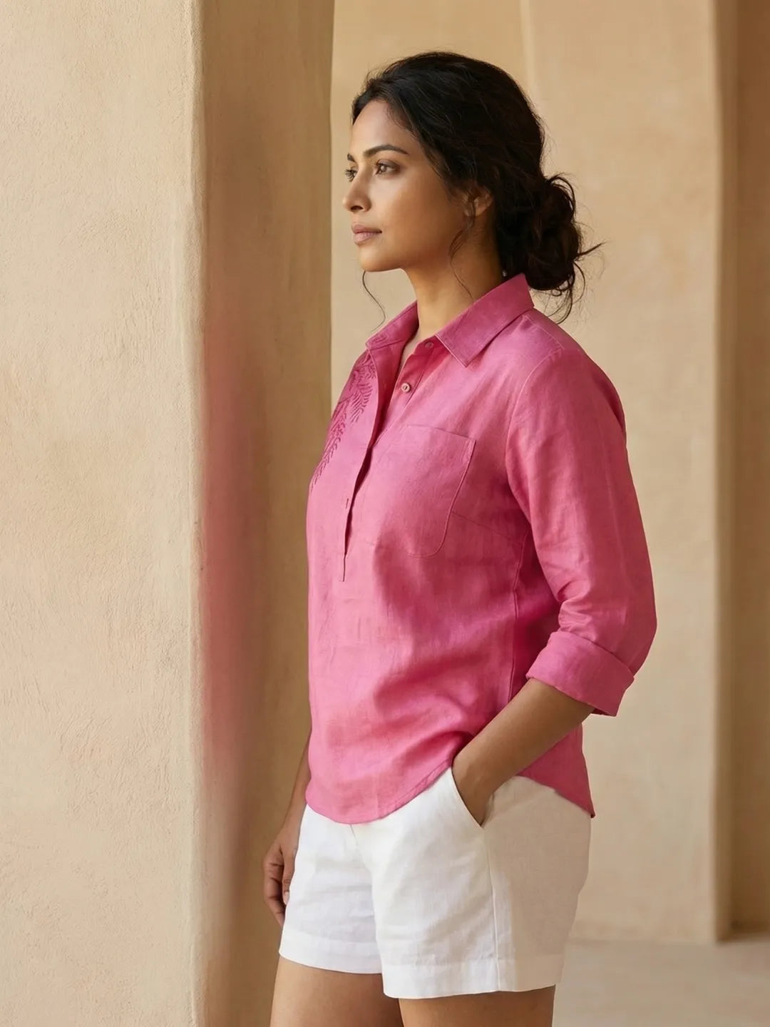 Side Profile of a women wearing Linen Blend summer co-ord set -  pink beach shirt with Embroidery and White Shorts with drawstring and pockets