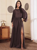 Woman wearing a brown co-ord set with crop top and Skirt with Slit in a room with decorative elements.