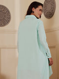 Back shot of a woman wearing a mint blue linen blend Shirt dress with embroidery 