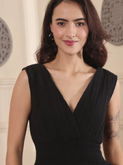 Woman wearing a black dress with a plain background