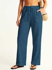 Person wearing teal resort pants on a white background