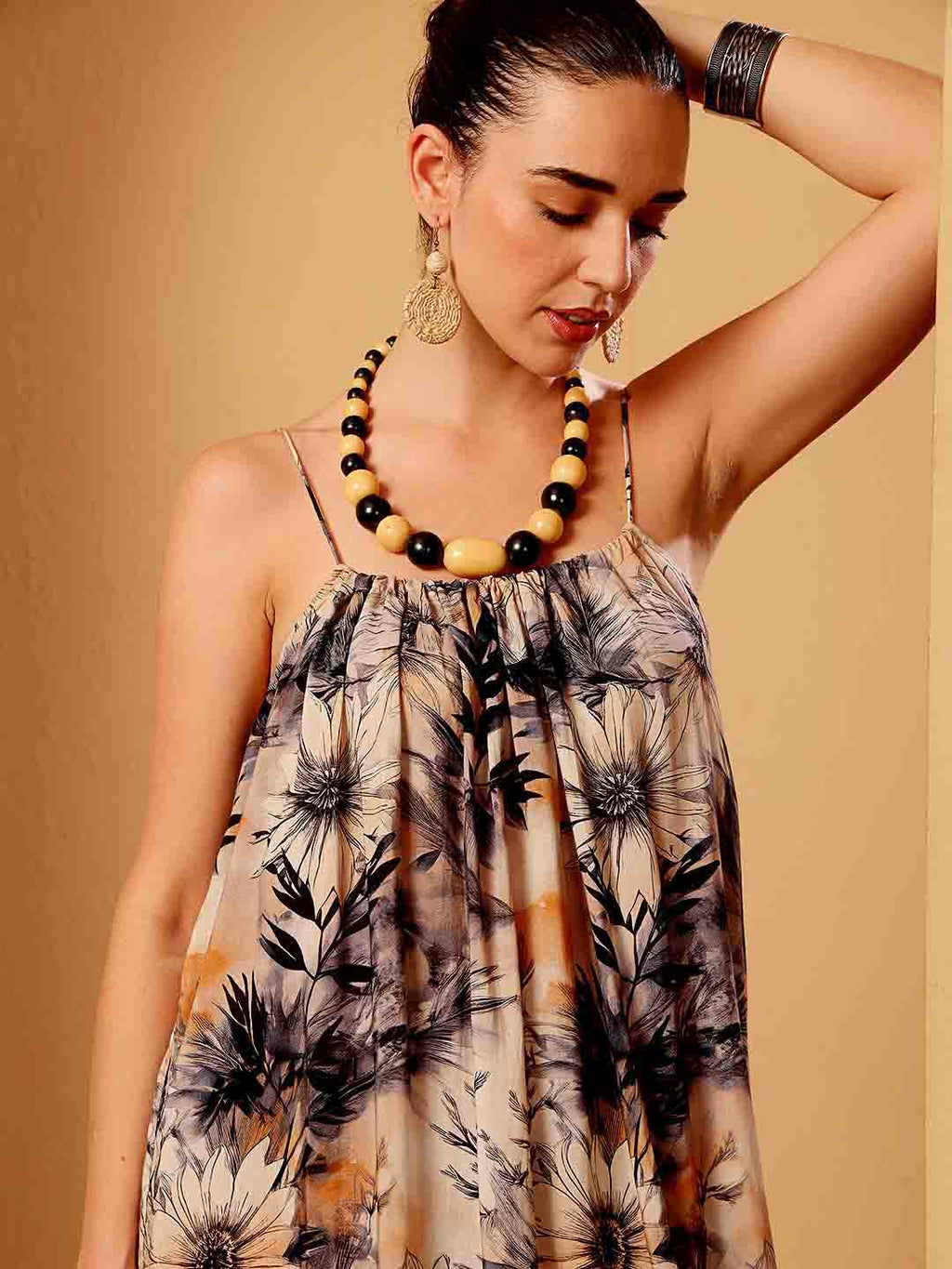 Close-up of tropical floral resort dress emphasizing fabric texture and detailed finish
