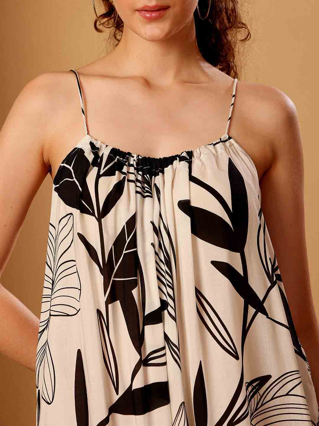 Front close-up of tropical printed resort maxi dress showing intricate fabric and neckline detail
