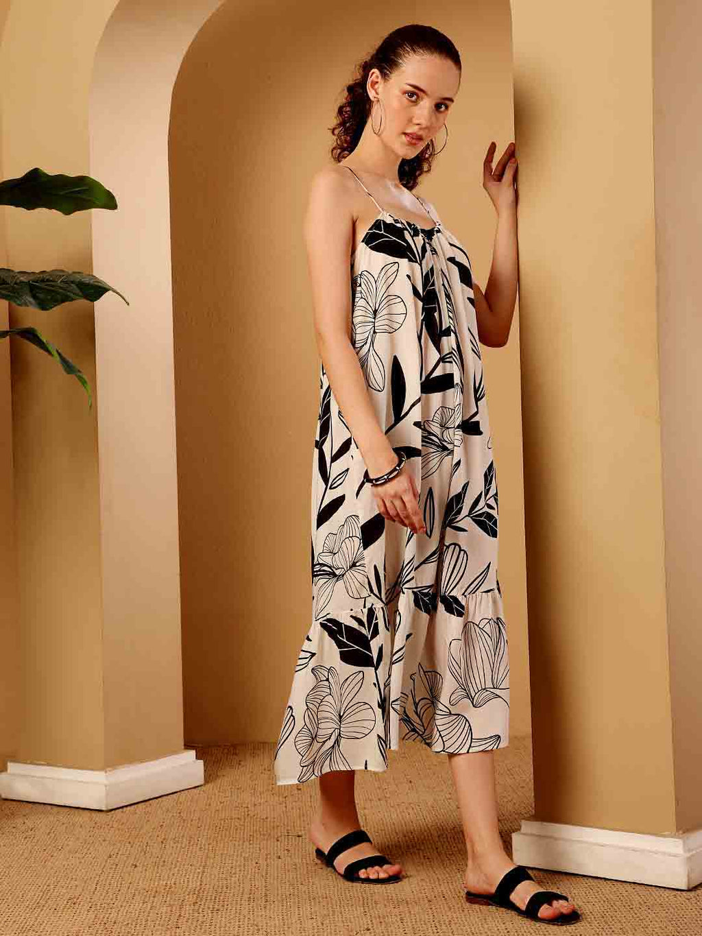 Side view of tropical printed resort maxi dress focusing on drape and contour
