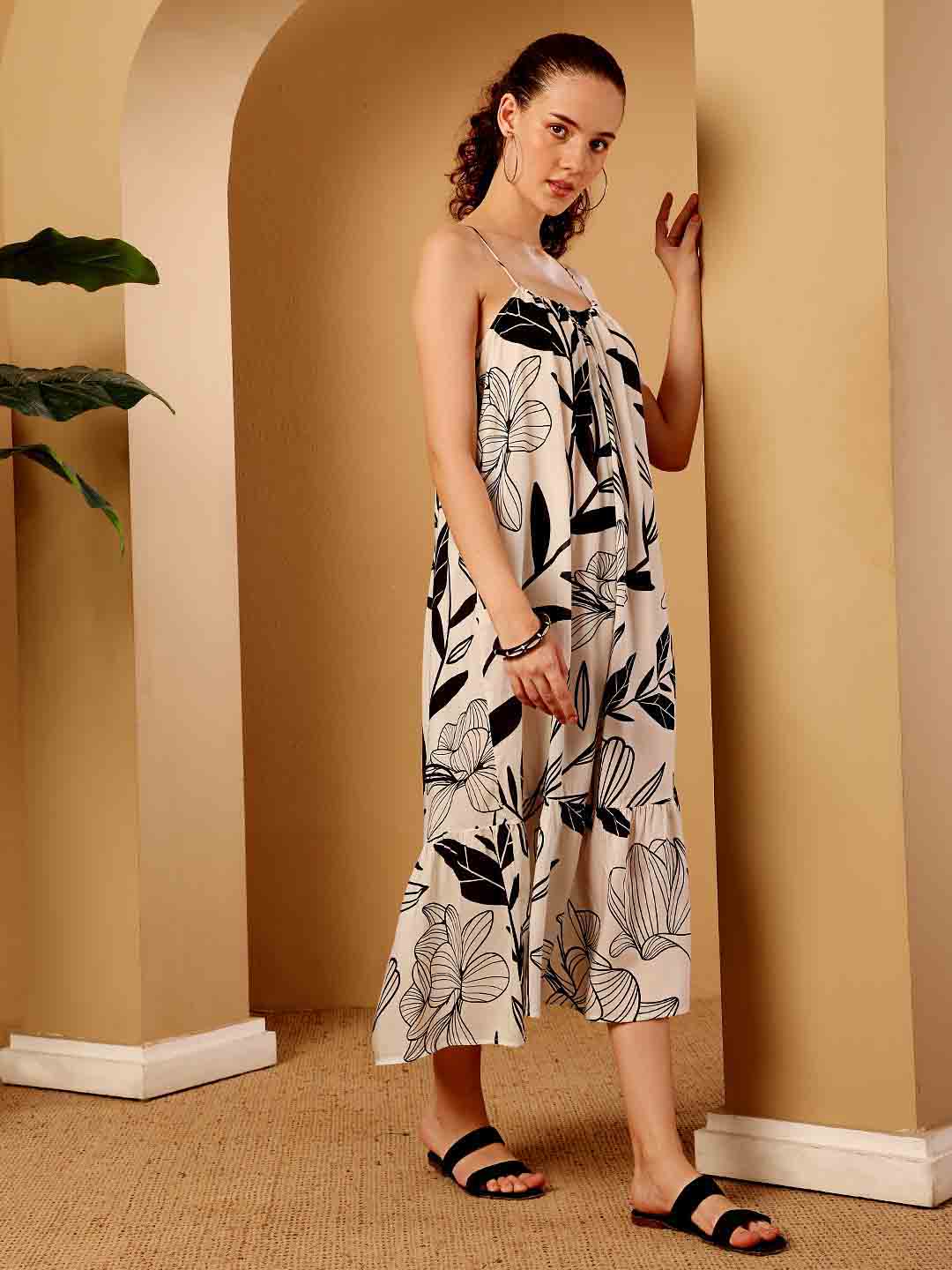 Side view of tropical printed resort maxi dress focusing on drape and contour
